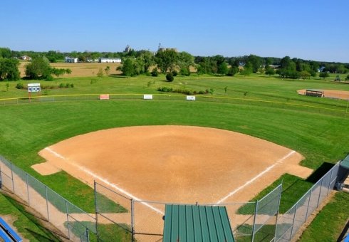 aerial view of baseball field surrounded with green grass