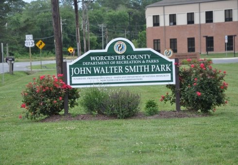 john walter smith park sign with small bushes 